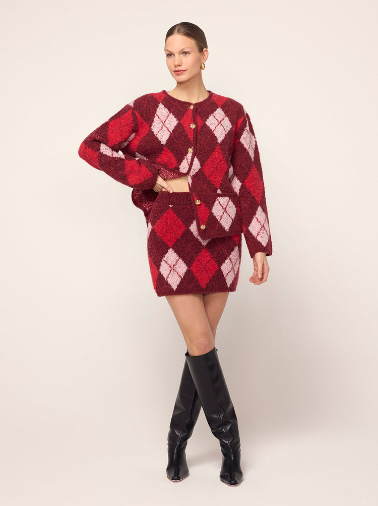 Susan Burgundy Argyle Knit Mini Skirt - Susan is a cosy mini skirt featuring a bold burgundy argyle. Her textured bouclé fabric makes her the perfect extra layer. Wear with your favourite tee or pair with matching Pandora Burgundy Argyle Knit Cardigan.