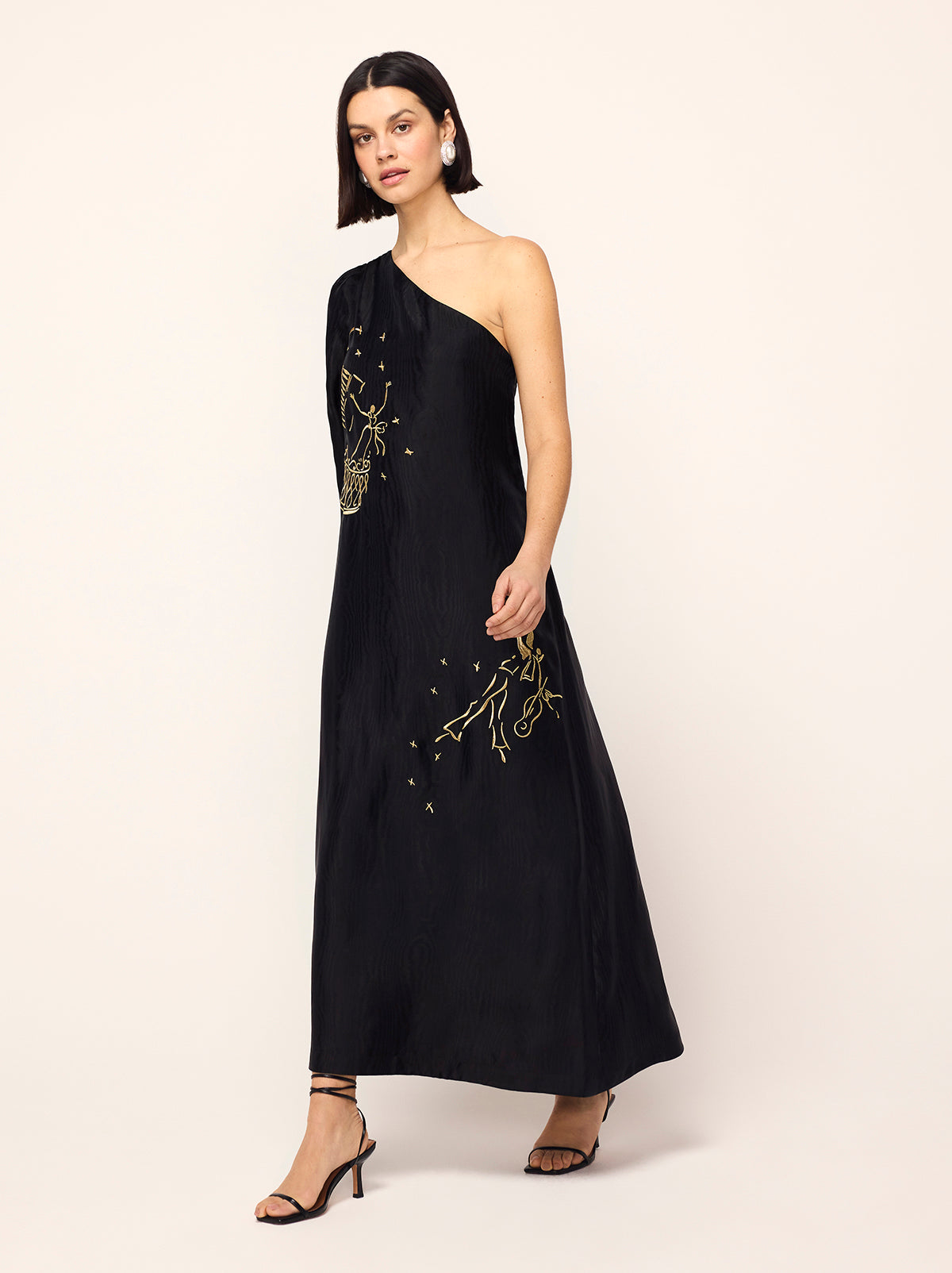 Vavara Black Opera Embroidered One Shoulder Maxi Dress - Vavara is a show-stopping one-shoulder wonder with a dramatic flared sleeve, ruched shoulder and show-stopping A-line silhouette. Crafted from premium, softly textured moiré fabric, Vavara features metallic gold placement embroidery, featuring figures inspired by the illustrations of Christian Berard.