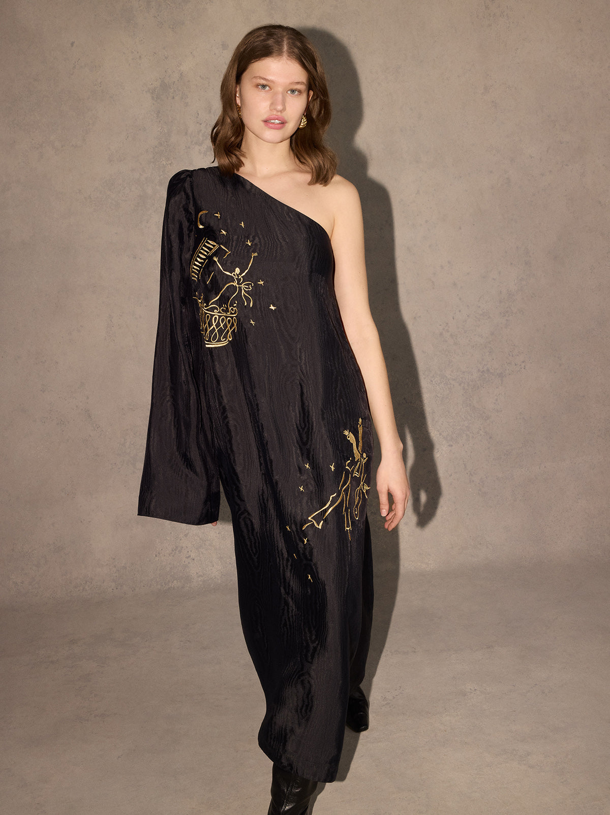 Vavara Black Opera Embroidered One Shoulder Maxi Dress - Vavara is a show-stopping one-shoulder wonder with a dramatic flared sleeve, ruched shoulder and show-stopping A-line silhouette. Crafted from premium, softly textured moiré fabric, Vavara features metallic gold placement embroidery, featuring figures inspired by the illustrations of Christian Berard.