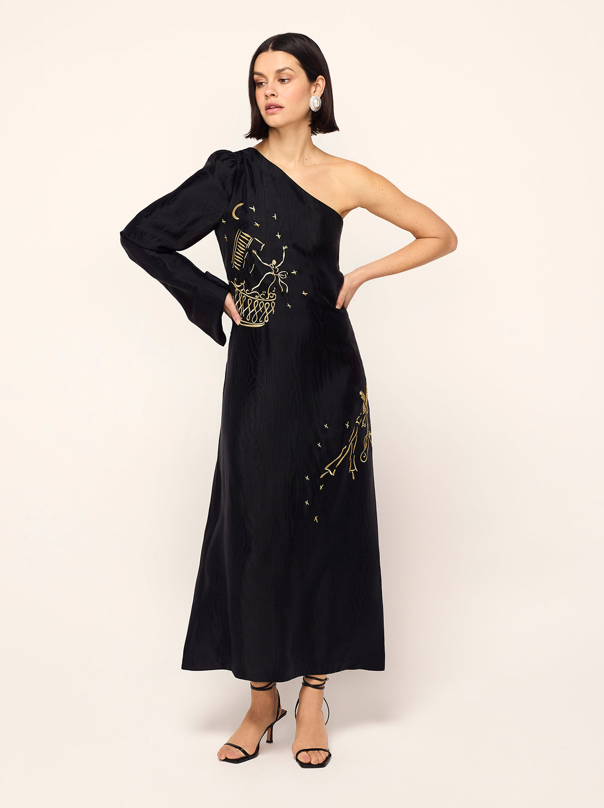 Vavara Black Opera Embroidered One Shoulder Maxi Dress - Vavara is a show-stopping one-shoulder wonder with a dramatic flared sleeve, ruched shoulder and show-stopping A-line silhouette. Crafted from premium, softly textured moiré fabric, Vavara features metallic gold placement embroidery, featuring figures inspired by the illustrations of Christian Berard.