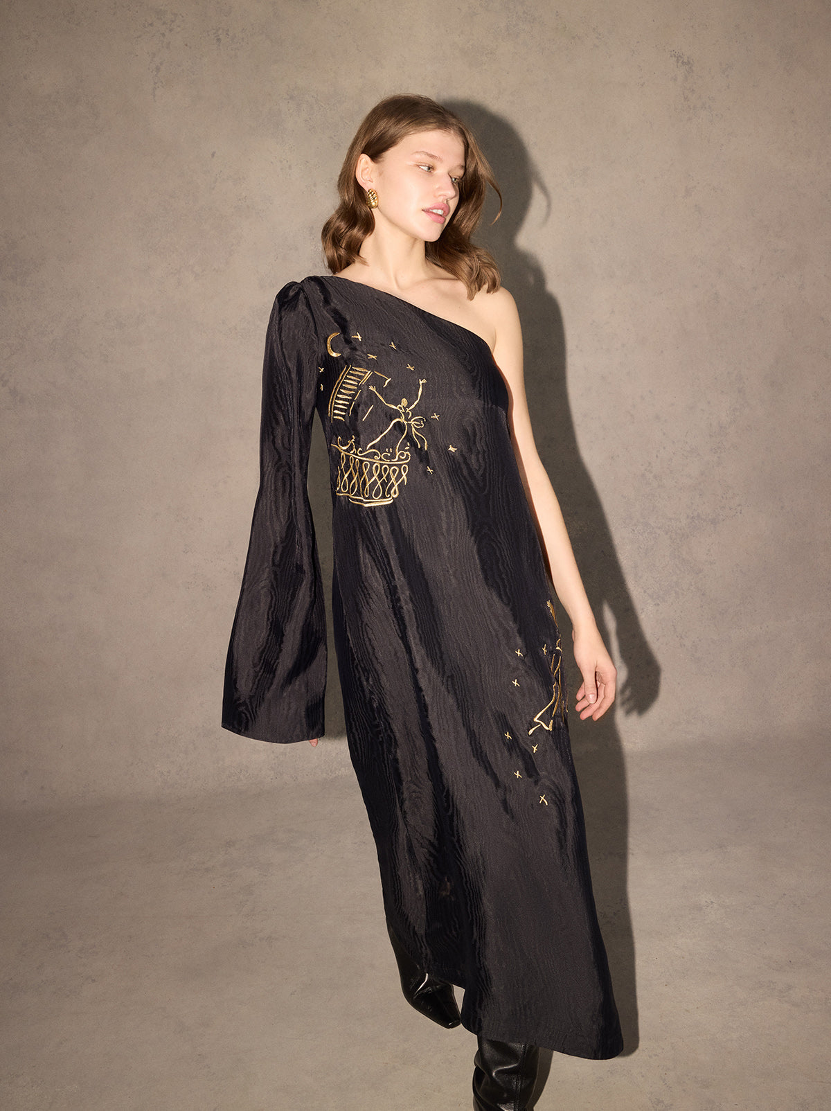 Vavara Black Opera Embroidered One Shoulder Maxi Dress - Vavara is a show-stopping one-shoulder wonder with a dramatic flared sleeve, ruched shoulder and show-stopping A-line silhouette. Crafted from premium, softly textured moiré fabric, Vavara features metallic gold placement embroidery, featuring figures inspired by the illustrations of Christian Berard.